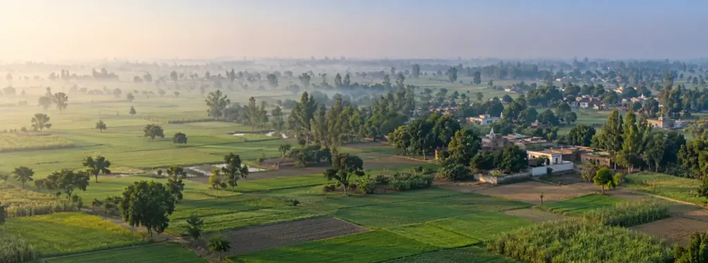YEIDA Notified Village List: aerial view of a patchwork of small agricultural fields and scattered village clusters with